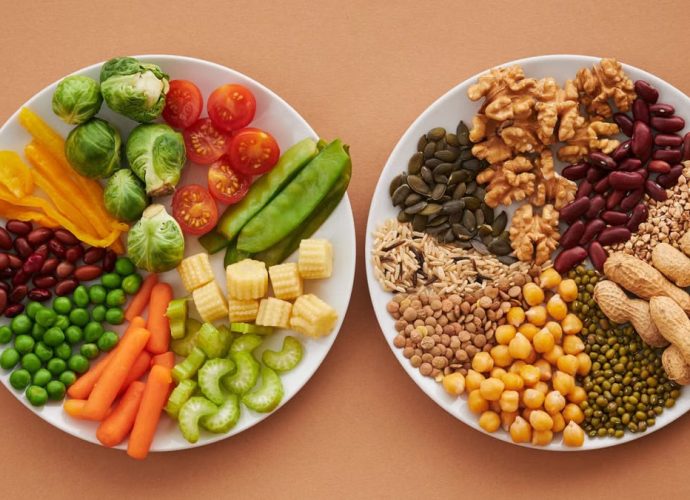 A vibrant flatlay of colorful vegetables and nuts showcasing a balanced diet concept.